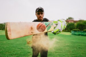 picture of a man hitting a cricket ball with a cricket bat