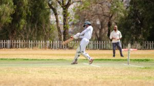 picture of a cricket game with umpire in the background